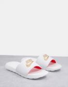 Nike Victori sliders in white and gold logo